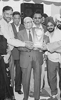 Old students and teachers honour founder-Principal B.P. Mohan at a function in Nehru Memorial College, Mansa.