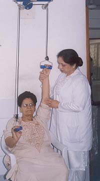 A patient being guided for limb exercises by a physiotherapist at the free physiotherapy camp which opened at the DMCH