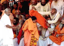 Sadhus from different parts of the country bless Uma Bharti after she took the oath as Madhya Pradesh Chief Minister in Bhopal on Monday