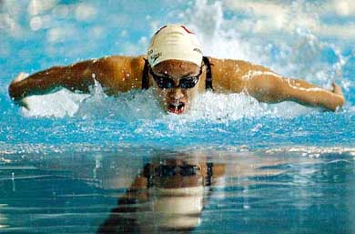 Singapore's Joscelin Yeo swims to win the gold medal in the 100m butterfly final event at the 22nd Southeast Asian Games in Hanoi
