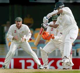 Rahul Dravid cuts as Adam Gilchrist and Matthew Hayden look on during the second innings of the first Test on Monday
