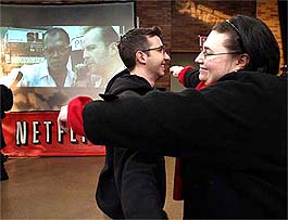 Ekin Binal and Cheryl Jones (R) hug each other after their group broke the Guinness World Record for non-stop movie watching