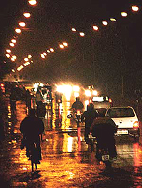 Traffic and streetlights mingle on the wet canvas of roads as the city received its first winter showers on Tuesday.