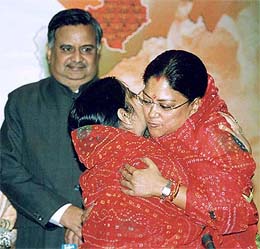 Newly-elected Chief Minister of Rajasthan Vasundhara Raje is hugged by Union Health Minister Sushma Swaraj at the BJP Parliamentary Party meeting