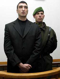 Ali Umit Demir, who was imprisoned for stabbing two English soccer fans to death, stands during his retrial in Istanbul