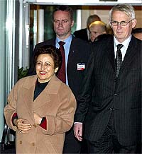 Nobel Peace Prize winner Shirin Ebadi walks with the Chairman of the Nobel Committee, Ole Danbolt Mjoes, as she arrives at Oslo airport on Monday