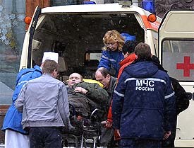 Emergency workers put an injured man into an ambulance outside the National Hotel in central Moscow on Tuesday