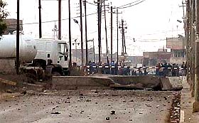 Debris lies scattered on the ground at the entrance to a US military barracks after an attack in Talafar