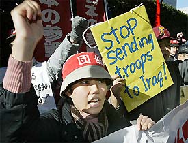 Japanese Prime Minister Junichiro Koizumi explains Japan's plan to dispatch troops to Iraq at a news conference in Tokyo on Tuesday