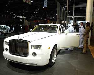 Visitors inspect the inside of the latest Rolls Royce car during the opening of a motorshow in Dubai on Thursday