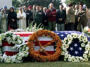 Relatives and friends of fallen Indian-born US soldier Uday Singh pray near his coffin during a wreath laying ceremony in Chandigarh 
