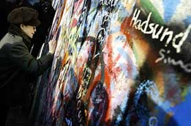 Yoko Ono, widow of late Beatles member John Lennon, writes a message on Prague's famous 'John Lennon Wall'