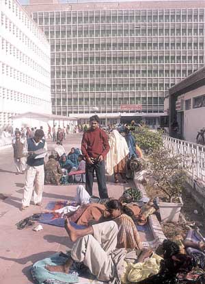 Patients stretch themselves on the All India Institute of Medical Sciences campus