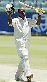 West Indies batsman Brian Lara celebrates after reaching his double century on the fourth day of the first Test against South Africa on Monday
