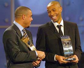Third placed Ronaldo of Brazil and second placed Thierry Henry of France jokes during the FIFA World Player 2003 award ceremony in Basel, Switzerland, on Monday