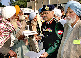 Brig Jatinder Singh, Station Commander, Bathinda Military Station, listens to grievances of war veterans on Tuesday.