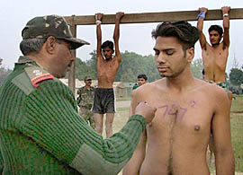 A youth gets his chest marked after performing the "beam" exercise during a recruitment rally