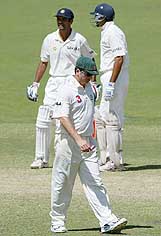 Australian captain Steve Waugh walks past Rahul Dravid and VVS Laxman