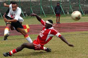 East Bengal's Brazlian striker, Junior, being tackled by Churchill Brothers' defender, Osumanu Husseni