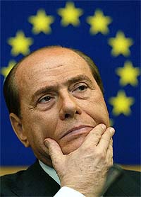 Italian Prime Minister Silvio Berlusconi attends a press briefing after a debate on the results of last weekend's European Summit