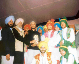 MP G.S. Galib honours the victorious bhangra team at the 12th Varinder Yaadgari Mela at Mullanpur Dakha