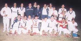 The U K World team, who lifted the Kehar Singh Under-15 Cricket Tournament Trophy at the Vikaspuri ground in the Capital, with their prizes.