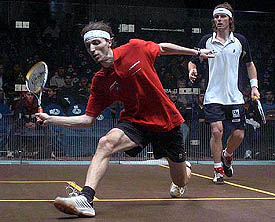 Davide Bianchetti of Italy (left) goes for a forehand drop shot against Peter Nicol of England
