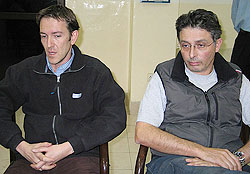 Two French journalists working for L'Express sit inside a police station in Karachi