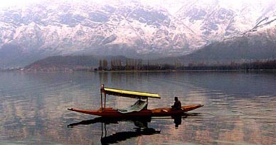 A Kashmiri man paddles his boat at Dal Lake in Srinagar on Thursday