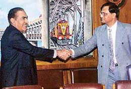 Pakistani Railways Additional General Manager Muhammad Iqbal Khatri shakes hands with Indian Railways Additional Secretary for Traffic S.B. Ghosh Dastidar