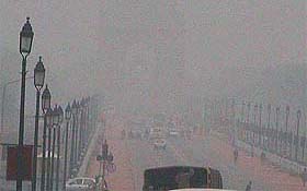 Thick fog engulf a street in New Delhi on Thursday