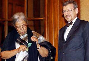 Eminent writer Mahasveta Devi inspects the second highest civilian award of France