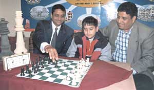 J�adoube: Parimarjan Negi makes a careful move with Pradeep Jain while Bharat Chauhan of Delhi Chess Association looks on at the Russian Culture Centre in New Delhi on Thursday.