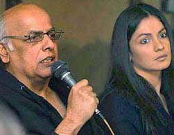 Indian filmmaker Mahesh Bhatt addresses a Press conference, as his daughter and actress Pooja Bhatt listens, in Karachi on Wednesday
