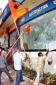 Shiv Sena activists break window panes of a shopping mall during a rampage at Mulund in north Mumbai on Sunday