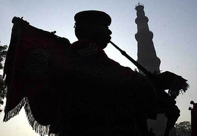 A Central Reserve Police Force band member perform at the 64th anniversary of CRPF in New Delhi 
