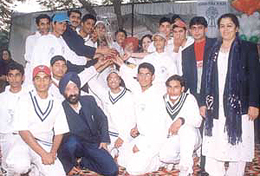 The Laxman Public School team, who lifted the inaugural Laxman International Cricket Tournament, display their prized possession.