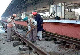 Railway technical staff repair the track at Attari Railway Station