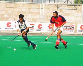 An Army XI player controls the ball during a league match against Punjab Police at the All-India Ramesh Chander Hockey tournament at Surjit Hockey Stadium in Jalandhar