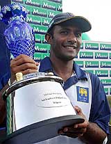 Sri Lankan captain Hashan Tillakaratne holds the winners trophy after defeating England