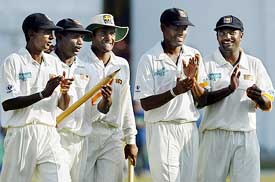 Sri Lanka's captain Hashan Tillakaratne, Muttiah Muralitharan , Thilan Samaraweera , Sanath Jayasuriya and Upul Chandana walk back jubilant after beating England 