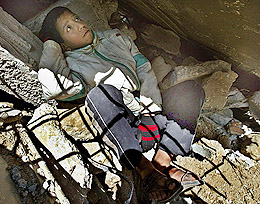 A Palestinian boy rests inside a destroyed house at a refugee camp in the southern part of Gaza strip on Sunday