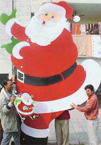 Mr David Messey  with the huge Santa he has made in Mohali. Christmas-related decorations, which have been selling like hot cakes