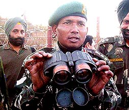 An Army officer displays a sophisticated night vision device seized from militants in Poonch district
