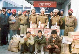 Policemen with the smugglers and the haul of smuggled liquor at Division No. 7 police station