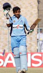 India 'A' batsman Gautam Gambhir holds the helmet after completing his century against Sri Lanka 'A'