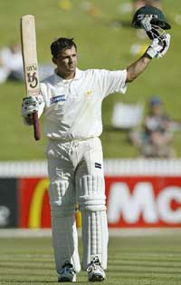 Pakistan's Moin Khan celebrates reaching 100 runs on the fourth day of the first Test between New Zealand and Pakistan in Hamilton
