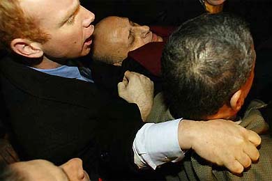 Egyptian Foreign Minister Ahmed Maher is carried away after he was assaulted by Palestinians while praying in Jerusalem's Old City