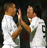 Chilean international Ivan Zamorano celebrates his first goal with Brazilian soccer star Ronaldo