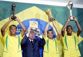 Brazilian captains Joao Guilherme of the U-17 team, Cafu of the national team,  Adailton dos Santos of the U-20 team and Brazilian Football Confederation President Ricardo Texeira  pose with their trophies